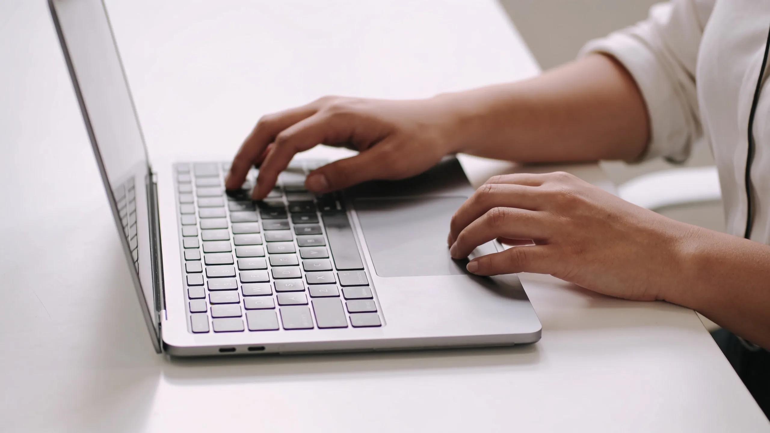 Person working on a laptop, showcasing social media automation in a creative office environment